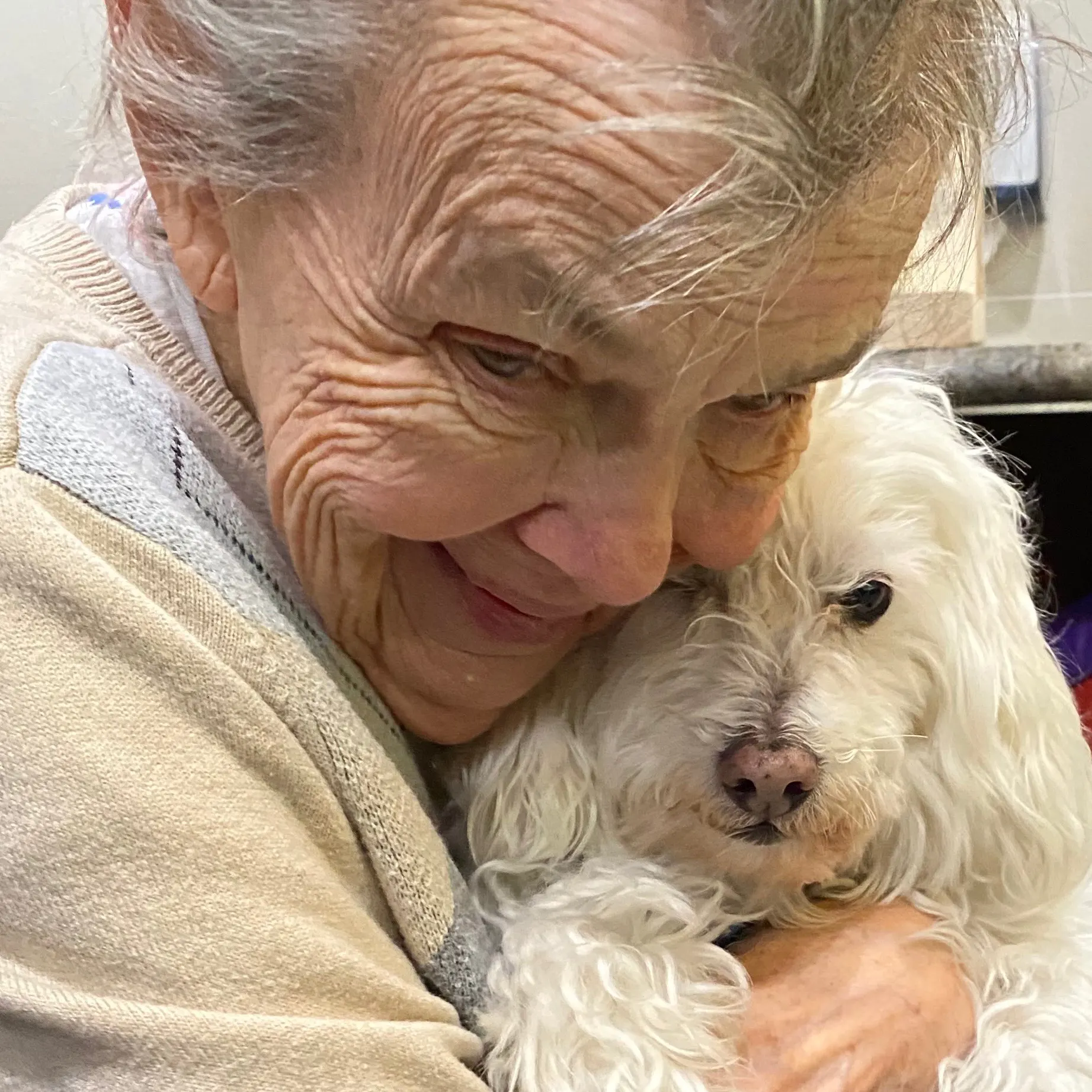 Senior Resident in Regency Park Hugging a Puppy